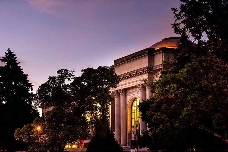 Memorial Union surrounded by trees at sunset